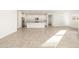 Open concept kitchen and dining area with tile floors and island at 36894 W La Paz St, Maricopa, AZ 85138