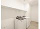 Laundry room with washer, dryer, and overhead shelving at 36894 W La Paz St, Maricopa, AZ 85138