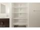 Bathroom with white shelves, quartz countertop, and modern silver faucet at 4958 W Hunter Trl, San Tan Valley, AZ 85144