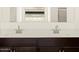 Modern bathroom featuring double sinks, sleek fixtures, and dark wood cabinetry at 4958 W Hunter Trl, San Tan Valley, AZ 85144