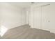 A simple bedroom with plush carpeting, a large closet, and neutral walls creating a cozy, inviting space at 4958 W Hunter Trl, San Tan Valley, AZ 85144