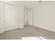 Carpeted bedroom with a double door closet and a doorway, providing ample space and storage at 4958 W Hunter Trl, San Tan Valley, AZ 85144