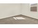 Clean, carpeted bedroom with a window offering natural light, perfect for relaxation and comfort at 4958 W Hunter Trl, San Tan Valley, AZ 85144