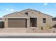 Charming single-story home with a well-manicured front yard and a two-car garage under a sunny, blue sky at 4958 W Hunter Trl, San Tan Valley, AZ 85144