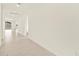 Bright hallway featuring clean, neutral walls and flooring, leading to various rooms in the home at 4958 W Hunter Trl, San Tan Valley, AZ 85144