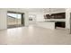 Open-concept living space with island, kitchen, and sliding glass doors leading to the yard at 4958 W Hunter Trl, San Tan Valley, AZ 85144