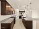 Spacious kitchen features granite countertops, stainless steel appliances, and dark cabinets at 4958 W Hunter Trl, San Tan Valley, AZ 85144