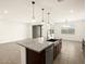 Modern kitchen features granite island, stainless steel appliances, and pendant lighting at 4958 W Hunter Trl, San Tan Valley, AZ 85144