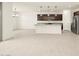 Open-concept living space featuring island, stainless steel appliances, and bright tile floors at 4958 W Hunter Trl, San Tan Valley, AZ 85144