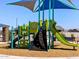 Community playground with climbing wall, shade structure and slides at 4958 W Hunter Trl, San Tan Valley, AZ 85144