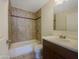 This bathroom features stylish tiling, a shower-tub combo, and a well-lit sink at 1446 S Revere --, Mesa, AZ 85210