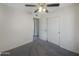 This bedroom features neutral carpet, a ceiling fan, and a closet with sliding doors at 1446 S Revere --, Mesa, AZ 85210