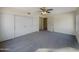 This bedroom has wall-to-wall carpet, a ceiling fan, and a large closet with sliding doors at 1446 S Revere --, Mesa, AZ 85210