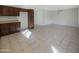 Spacious kitchen featuring dark wood cabinetry, tile flooring, and an adjoining dining area for easy meals at 1446 S Revere --, Mesa, AZ 85210