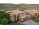 Stunning aerial view of a two-story home with a tile roof and landscaped yard at 1622 E Nighthawk Way, Phoenix, AZ 85048