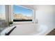 Bathroom with soaking tub and window showcasing mountain views at 1622 E Nighthawk Way, Phoenix, AZ 85048