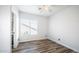 Simple bedroom with wood-look floors and a window with blinds at 1622 E Nighthawk Way, Phoenix, AZ 85048