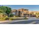 Two-story home with stone accents, a three-car garage, and lush landscaping at 1622 E Nighthawk Way, Phoenix, AZ 85048