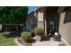 Welcoming front entrance with stone accents, arched windows, and landscaping at 1622 E Nighthawk Way, Phoenix, AZ 85048