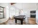 Game room with pool table, hardwood floors, and large windows at 1622 E Nighthawk Way, Phoenix, AZ 85048