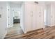 Long hallway with white cabinets and wood-look floors at 1622 E Nighthawk Way, Phoenix, AZ 85048
