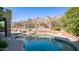 Serene kidney-shaped pool reflecting the sky and surrounding landscape at 1622 E Nighthawk Way, Phoenix, AZ 85048