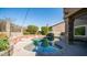 Relaxing kidney-shaped pool surrounded by a brick patio and lush landscaping at 1622 E Nighthawk Way, Phoenix, AZ 85048
