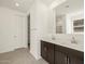 Double vanity bathroom with dark brown cabinets and a large mirror at 22542 W Tonopah Dr, Surprise, AZ 85387