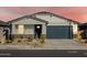 One-story house featuring a dark gray garage door and desert landscaping at 22542 W Tonopah Dr, Surprise, AZ 85387