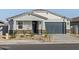 New construction home with gray exterior, landscaping, and a two-car garage at 22542 W Tonopah Dr, Surprise, AZ 85387