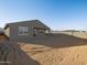 Single-story home with covered patio and sandy backyard at 22550 W Tonopah Dr, Surprise, AZ 85387