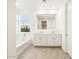Bathroom features double vanity and large mirror at 22550 W Tonopah Dr, Surprise, AZ 85387