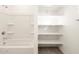 Bathroom with tub, shower, and shelving at 22550 W Tonopah Dr, Surprise, AZ 85387