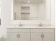 Double vanity with large mirror in bright bathroom at 22550 W Tonopah Dr, Surprise, AZ 85387