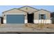 One-story house with blue garage door, landscaping, and light-colored exterior at 22550 W Tonopah Dr, Surprise, AZ 85387