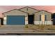 One-story house with blue garage door, landscaping, and light-colored exterior at 22550 W Tonopah Dr, Surprise, AZ 85387