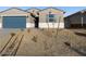 One-story house with blue garage door, landscaping, and light-colored exterior at 22550 W Tonopah Dr, Surprise, AZ 85387
