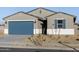 One-story house with blue garage door, landscaping, and light-colored exterior at 22550 W Tonopah Dr, Surprise, AZ 85387
