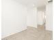 Clean and bright hallway with tile flooring, leading to other rooms at 22550 W Tonopah Dr, Surprise, AZ 85387
