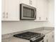 Stainless steel microwave and gas cooktop in a modern kitchen at 22550 W Tonopah Dr, Surprise, AZ 85387