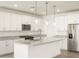 Modern kitchen with white cabinets, granite counters, and stainless steel appliances at 22550 W Tonopah Dr, Surprise, AZ 85387