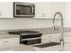 Modern kitchen with stainless steel sink and faucet, granite countertops at 22550 W Tonopah Dr, Surprise, AZ 85387
