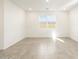 Spacious living room featuring tile flooring and large window at 22550 W Tonopah Dr, Surprise, AZ 85387