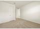 Spacious bedroom with neutral carpet and door at 36914 W La Paz St, Maricopa, AZ 85138