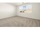 Bright bedroom with neutral carpeting and large window at 36914 W La Paz St, Maricopa, AZ 85138