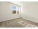 Simple bedroom with neutral walls, carpet flooring, and a window with blinds at 36914 W La Paz St, Maricopa, AZ 85138