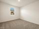 Bright bedroom with neutral carpet and window at 36914 W La Paz St, Maricopa, AZ 85138