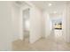 Bright and airy hallway with tile flooring and access to other rooms at 36914 W La Paz St, Maricopa, AZ 85138