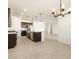 Modern kitchen with island and stainless steel appliances at 36914 W La Paz St, Maricopa, AZ 85138