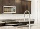 Kitchen boasts stainless steel appliances and granite countertops at 36914 W La Paz St, Maricopa, AZ 85138